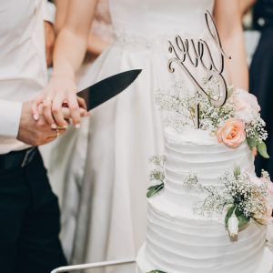 bride-and-groom-cutting-stylish-wedding-cake-at-wedding-reception.jpg