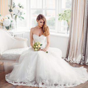 bride-in-beautiful-dress-sitting-resting-on-sofa-indoors.jpg